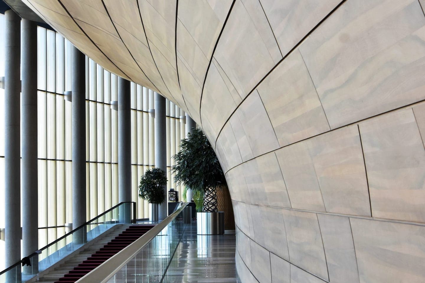 Curved hallway with tall windows in a modern building